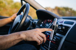 man using phone while driving