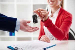 man getting keys for a rental car