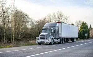 semi truck driving down a road