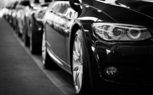 Row of production vehicles lined up in an automotive manufacturing facility