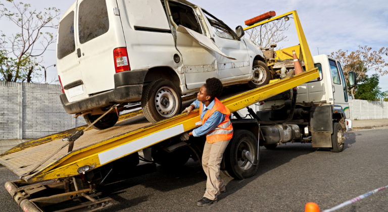 damaged Worker truck loaded onto a tow truck